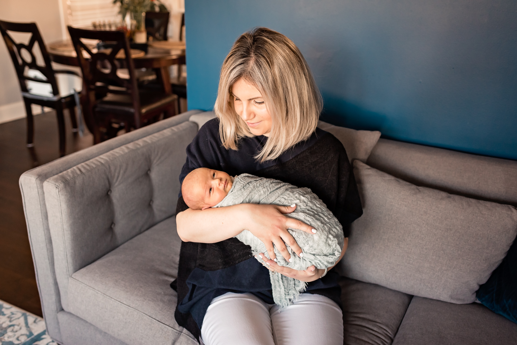 mom holding baby in home Valley Village Newborn Pictures